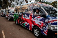 A driver parks a van set to be part of the royals' convoy and decorated by Kenyan artists