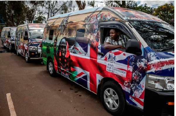 A driver parks a van set to be part of the royals' convoy and decorated by Kenyan artists