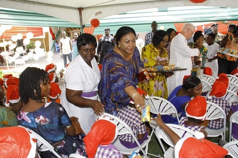 Mrs Rebecca Akufo-Addo handing out goodies to some children of Princess Marie Louise Hospital
