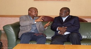 Togbe Afede with an official of the Zimbabwean government