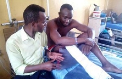 Hardi Akalifa(R) on his hospital bed with his injured leg