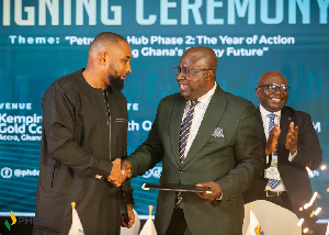 CEO of PHDC, Dr Toni Aubynn (R) in a handshake with Boubacar Belco Bah (L)