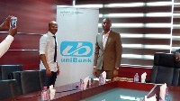 Dede Ayew with a UniBank official