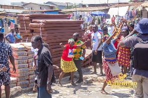 Traders jubilate over the items that were distributed to them by Valentino Nii Noi Nortey