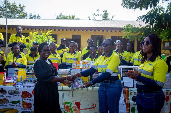 A headmistress receiving items from Newmont BRG