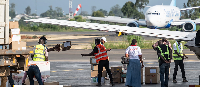 People offload supplies at Bunia National Airport as part of the response to the Ebola outbreak