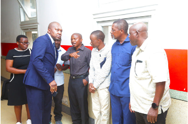 Lawyer Peter Kibatala (second left) confers with Mr Humphrey Polepole’s relatives at the High Court