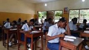 Students busily writing their BECE exams