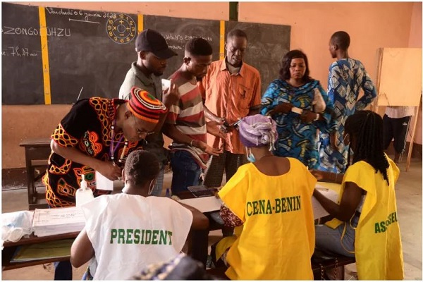 People check their names as they prepare to cast their ballots