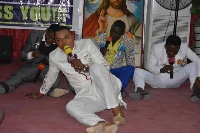 Bishop Daniel Obinim with his junior pastors praying