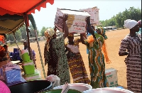 A picture of some women beneficiaries buying materials and equipment related to their business plans