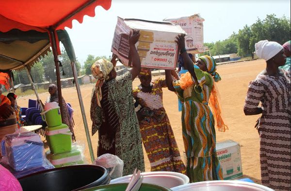 A picture of some women beneficiaries buying materials and equipment related to their business plans