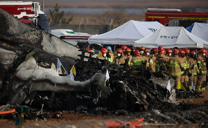 Rescue workers take part in a salvage operation at the site where an aircraft crashed