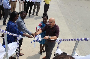 Some tigo officials cutting the tape to launch the project