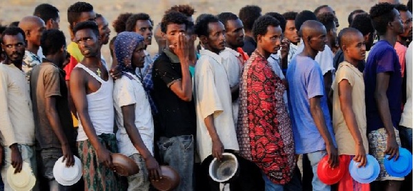 Ethiopians who fled fighting in Tigray queue for food at Um-Rakoba camp on the Sudan-Ethiopia border