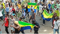 People celebrate in support of the putschists in a street of Libreville, Gabon August 30