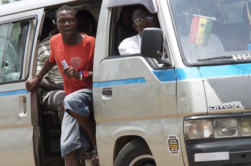 'Trotro mate' in the busy street of Accra