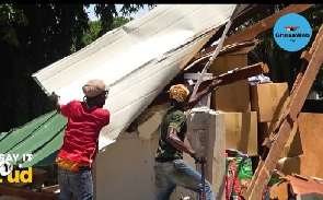 Some workers trying to salvage what is left of the building