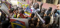 Ida Alira Adiyone in a group photo with school children