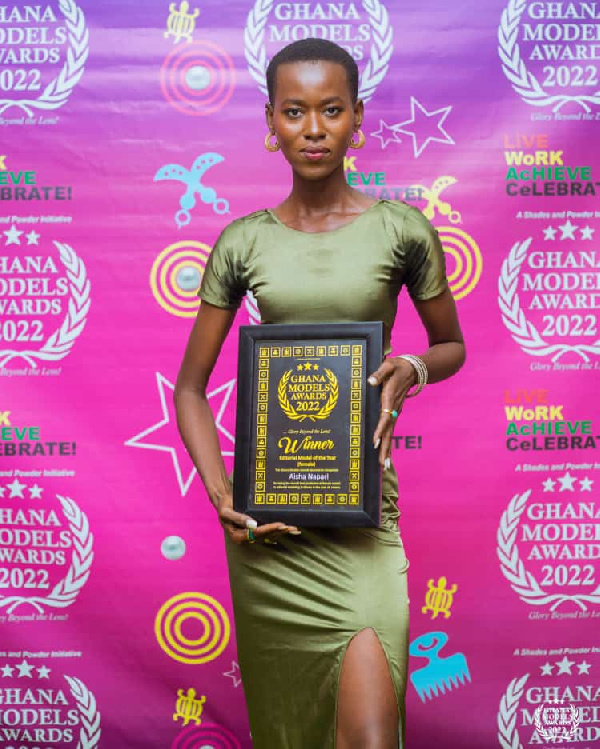 Aisha Napari holding her award at the event