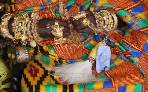 A chief with gold ornaments around his wrists and fingers