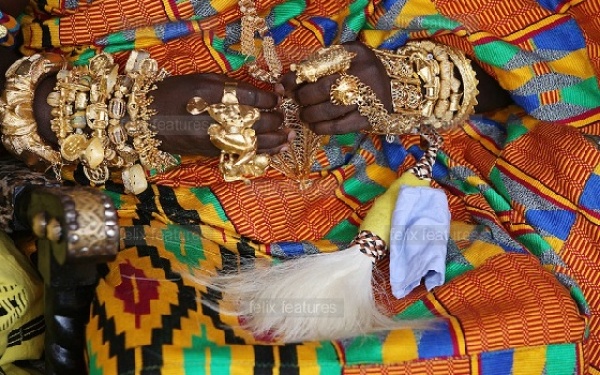 A chief with gold ornaments around his wrists and fingers