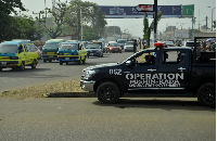 A police vehicle of Operation Fushin Kada (Anger of Crocodile) is parked on Yakowa Road