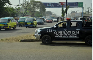 A police vehicle of Operation Fushin Kada (Anger of Crocodile) is parked on Yakowa Road
