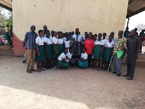 The chief in a group picture with students of Tuna Girls Model School