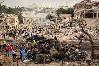 Soldiers inspect damage following an attack by opposition forces, Baidoa, Somalia