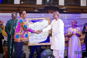 Prof Kwesi Yankah presenting a citation to Dr (Alhaji) Abubakari Sidick Ahmed