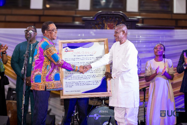 Prof Kwesi Yankah presenting a citation to Dr (Alhaji) Abubakari Sidick Ahmed
