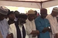 The Chief Imam (M) surrounded by other imams to offer the Janazah prayers