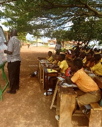 Pupils of Akyeremade D/A Primary and JHS studying under trees