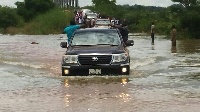 Nana Addo's convoy driving through the water on the bridge that links Yendi to Saboba.