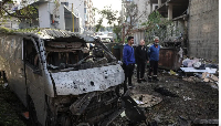 The wreckage of a vehicle at the site of an Israeli strike in Beirut’s southern suburbs