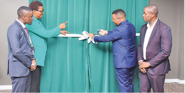 The Bank of Africa – Tanzania managing director Adam Mihayo (right) cuts a ribbon during the launch