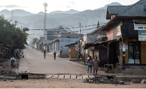 Congolese civilians walk after returning to their homes following displacement during  clashes