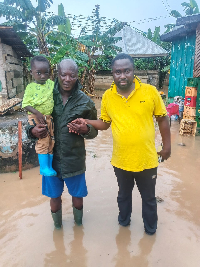 Abuakwa South NADMO director (R) with a resident