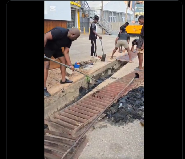 John Dumelo spotted in black attire, holding a shovel during scenes from the cleanup exercise