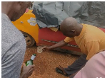 Some elders at the crime scene pouring libation for justice to prevail