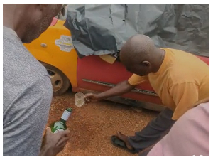 Some elders at the crime scene pouring libation for justice to prevail