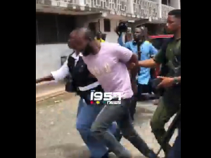 Thomas Zigah being escorted to the court by CID officials