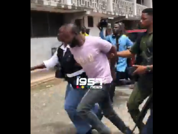 Thomas Zigah being escorted to the court by CID officials