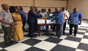 Mr. George Mireku Duker presents donations to GES representatives