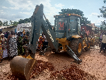 The Regional Minister operating an equipment to signify the commencement of construction works.