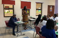 Professor Robert Ebo Hinson sitting and observing one of the classes during the conference