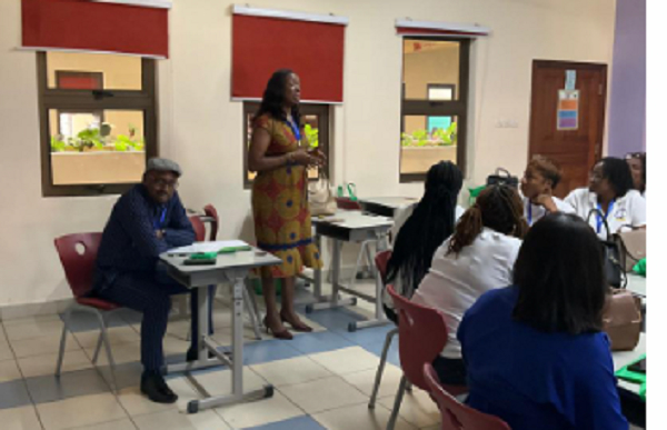 Professor Robert Ebo Hinson sitting and observing one of the classes during the conference