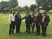 Prof Baiden (2ndL) receiving the package from Ackorful, with them are staff of the bank