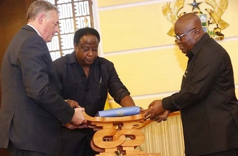 President Akufo-Addo presenting a gift to Mr. Pojolas (left), Out-Going French Ambassador to Ghana